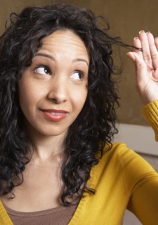 Hispanic woman playing with hair