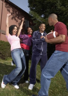 Multi-ethnic friends playing football