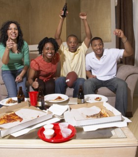 Multi-ethnic friends watching sports on television