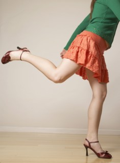 Mixed Race woman wearing mini skirt and high heels