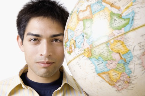 Pacific Islander man next to globe