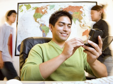 Pacific Islander businessman using electronic organizer