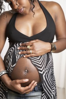 Pregnant African American woman with hands on belly