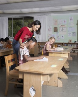 Indian female teacher helping student