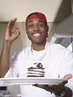 African American male chef holding desert