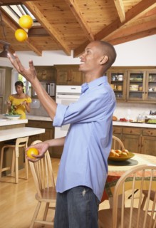 African man juggling fruit