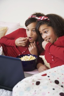 African twin sisters watching movie