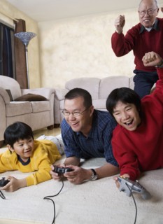 Multi-generational Asian family playing video games