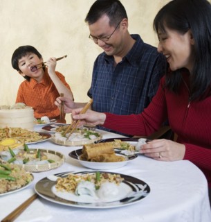 Asian family eating at dinner table