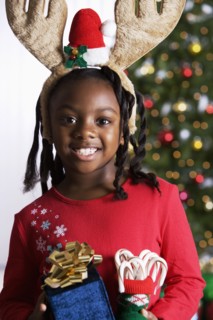 African girl holding Christmas gifts