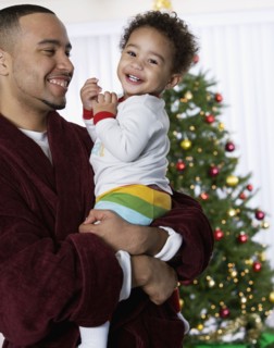 African father and baby laughing