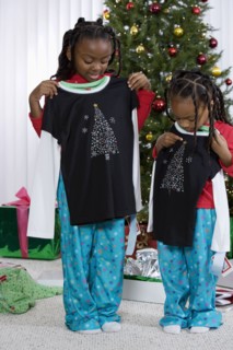 African sisters holding matching Christmas gifts