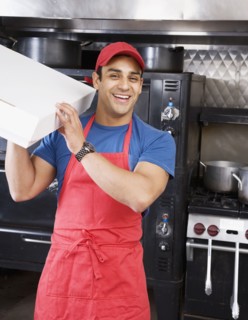 Hispanic male pizza maker holding box