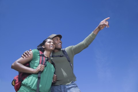 Multi-ethnic couple backpacking