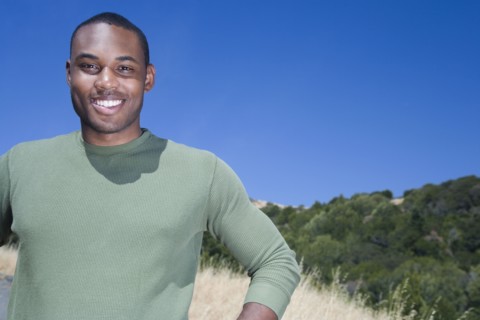Mixed race man standing in rural area
