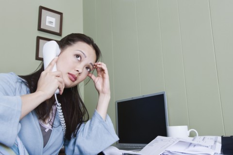 Stressed woman talking on telephone