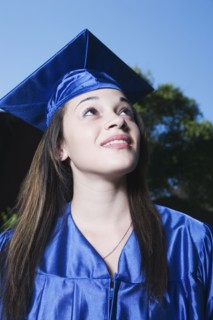 Mixed race girl in graduation cap and gown