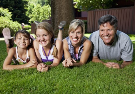 Caucasian family laying in grass