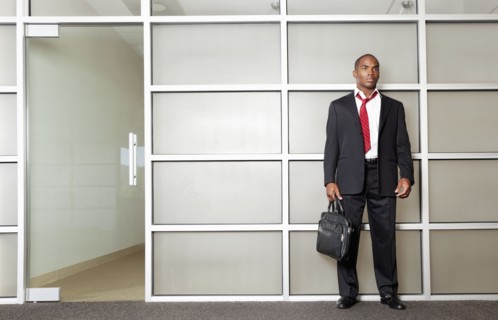 Mixed race businessman standing in modern office