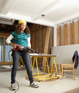 Hispanic woman holding power tool
