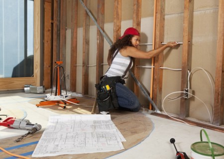 Hispanic woman wiring construction site