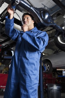 Middle Eastern mechanic working on car
