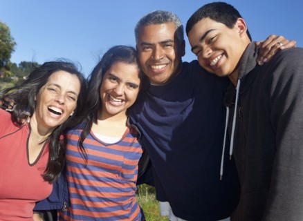 Hispanic family smiling in park