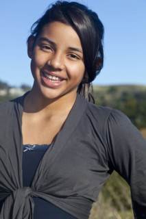 Hispanic teenage girl smiling outdoors