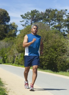 Mixed race man running on rural road