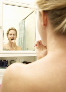 Caucasian woman brushing her teeth