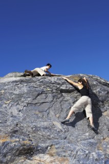 Climbers scaling steep rock face