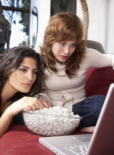 Women watching movie on laptop together