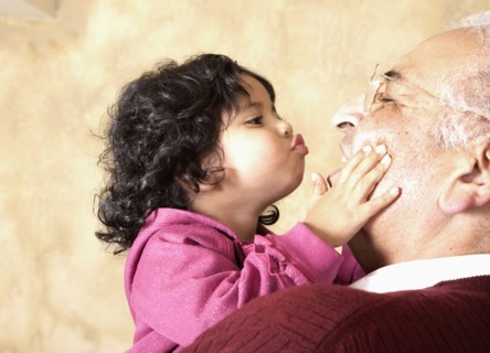 Hispanic girl kissing grandfather