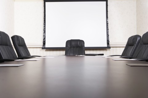 Empty chairs at conference table
