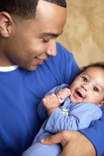 Smiling father holding baby