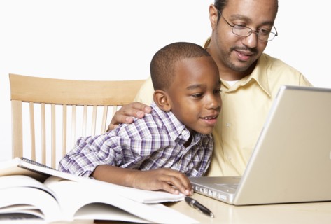 African American father helping son with homework