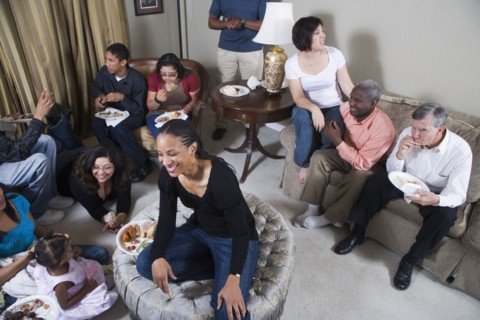 Multi-generation family relaxing together in living room