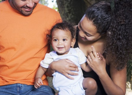 Couple holding baby outdoors