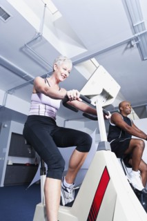 People using exercise machines in gym