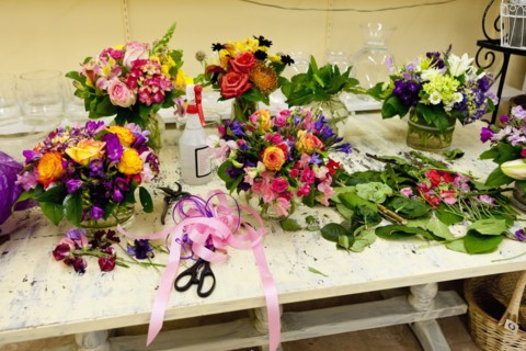 Flower arrangements on work table in florist