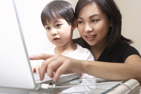 Filipino mother and son using laptop together
