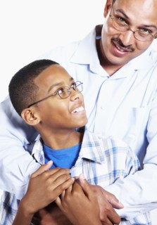 Smiling father hugging son