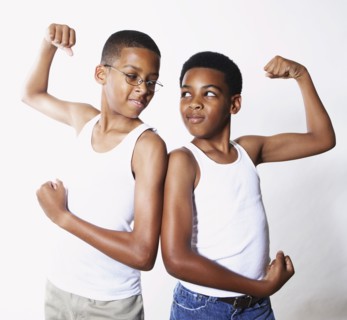 Mixed race boys flexing their muscles