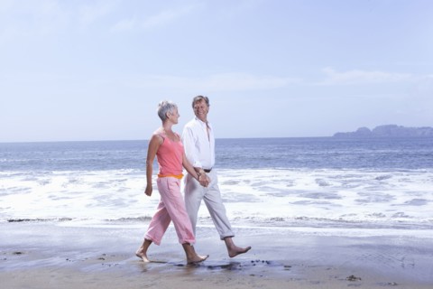 Senior Caucasian couple walking on beach