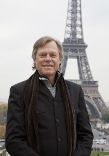 Caucasian man standing in front of Eiffel Tower