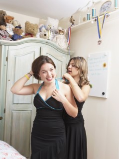 Teenage girls getting ready for dance together