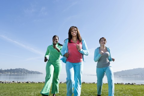Women jogging by rural lake