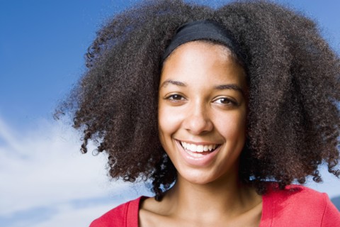 Mixed race teenage girl smiling outdoors