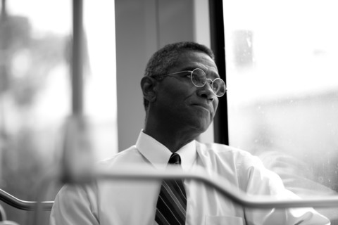 Mixed race businessman rising commuter train