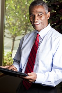 African American businessman using electronic tablet